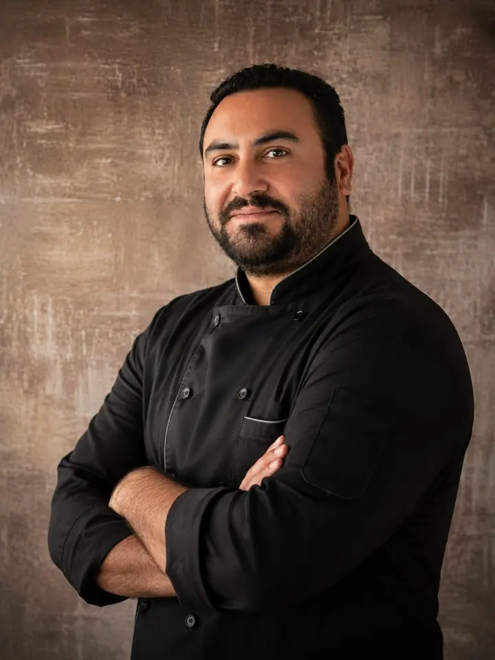 Chef Pat Minassian in a black chef's coat
